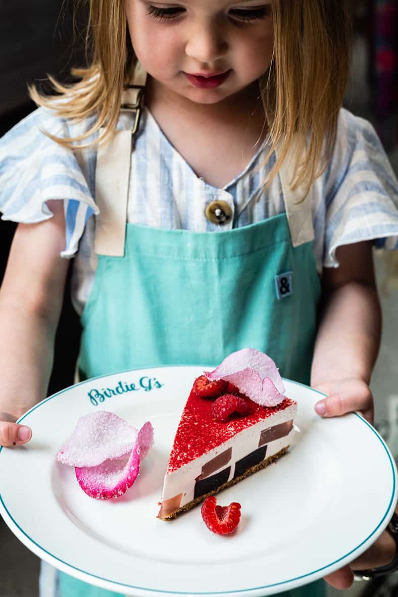 Birdie holding a slice of World Famous Rose Petal Pie