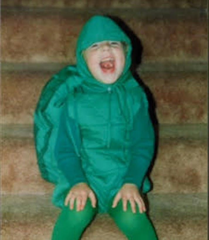 Baby photo of Chanel dressed as a dinosaur